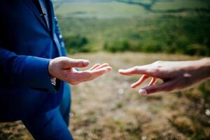 Close-up of a woman and a man holding out their hands, two people holding hands. The symbol is a sign of sincere feelings, a loved one. the concept of true friendship, outdoors photo