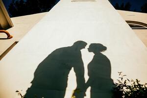 silhouette of a man and a woman, outdoors, shadows from people photo
