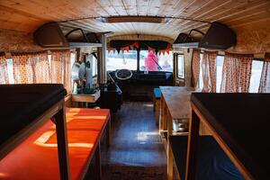 bus in the forest equipped with sleeping places with a stove. the interior of the hut, beds in two tiers in a hut in the woods. hunter's home. a tourist shelter. photo