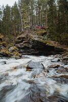 a bubbling stream of water in a mountain stream. river among autumn trees in the taiga. golden autumn in the Urals. nature of Russia photo