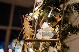A christmas tree with a bear and a tree ornament photo