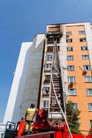 red fire truck, fire fighting, fireman, rescue ladder ladder, burning residential multi-storey building photo