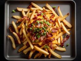 french fries with crispy bacon on top photo