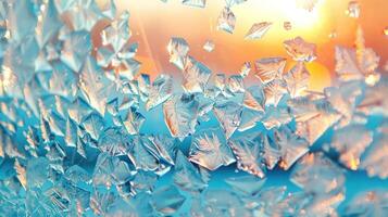 Abstract frost patterns on a windowpane with a warm sunset in the background. photo