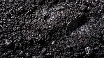 Close-up of black charcoal, a natural material with a rough texture. photo