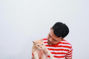 portrait of a young asian man happy while holding his ginger cat photo