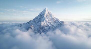 Majestic snow capped mountain peak above the clouds photo