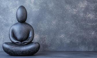 Serene black stone figure in meditative pose photo