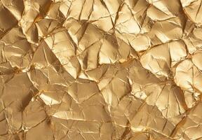 Crumpled golden foil texture background photo