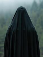 Mysterious figure in black cloak photo