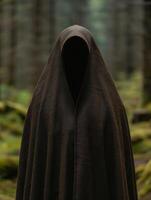 Mysterious hooded figure in the forest photo