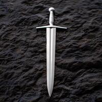 medieval sword on dark rock background photo