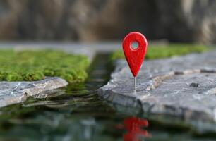 red map pin on rock with moss and reflection photo