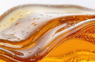 Close up of golden honey dripping from a spoon photo