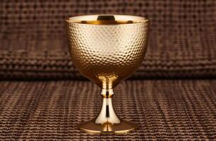 golden chalice on textured background photo