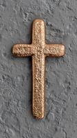 golden cross on gray concrete background photo