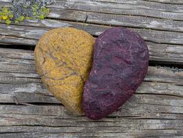 Weathered wooden boards with heart shaped stones photo