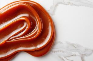 Swirling patterns of caramel sauce on a white background photo