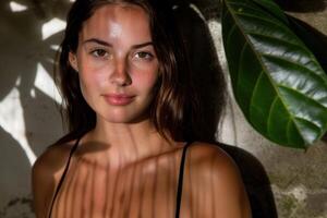 Thoughtful young woman in tropical setting photo
