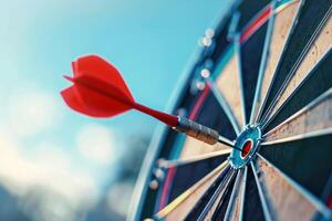 Red dart hitting the bullseye on a colorful dartboard photo