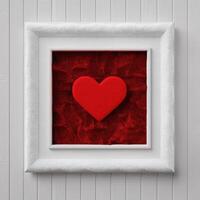Framed red heart on red fur background photo
