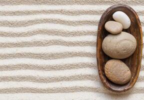Zen stones and eggs on wooden tray photo