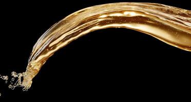 Flowing golden liquid splash on black background photo