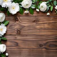 Floral frame with white flowers on wooden background photo