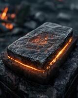 Glowing hot coal briquette on a dark background photo
