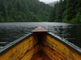 Wooden Canoe Floating on Serene Lake Surrounded by Lush Evergreen Forest photo