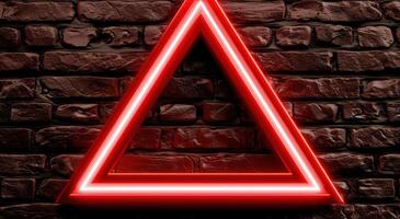 Glowing red triangle on brick wall photo