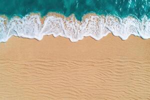 Waves crashing on sandy beach photo