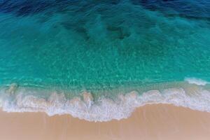 Stunning turquoise ocean waves crashing on sandy beach photo