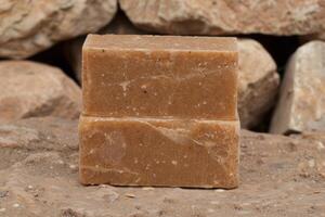 Handmade natural soap bar on rocky surface photo