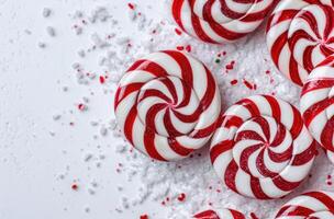 Festive red and white candy cane swirls on a snowy background photo