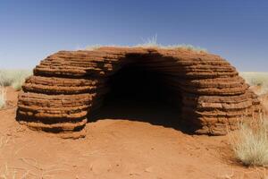 Entrance to a natural rock formation in the desert photo