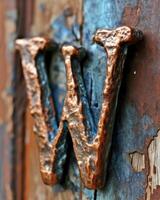 Rusty metal hooks on a weathered wooden surface photo