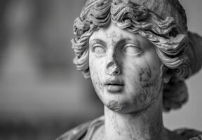 Weathered stone statue of a classical figure photo