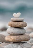 Stacked zen stones with a heart shaped rock photo