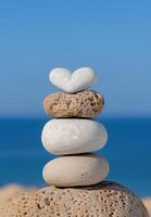 Balanced stones on a blue background photo