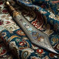 Ornate dagger on intricate patterned fabric photo