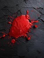 Dramatic red paint splash on dark background photo