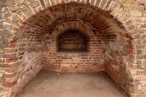 Brick archway in an old stone wall photo