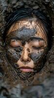 Closeup of a persons face covered in mud photo