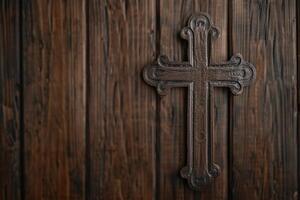 Ornate wooden cross on rustic background photo