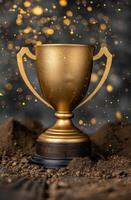 golden trophy award on dirt background with sparkling lights photo