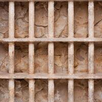 Weathered stone wall with concrete columns photo