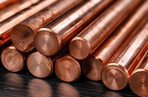Copper rods and pipes stacked in a metalworking shop photo