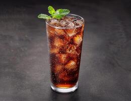 Refreshing iced cola drink with mint garnish photo