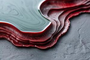 Vibrant red meat slices on a textured surface photo